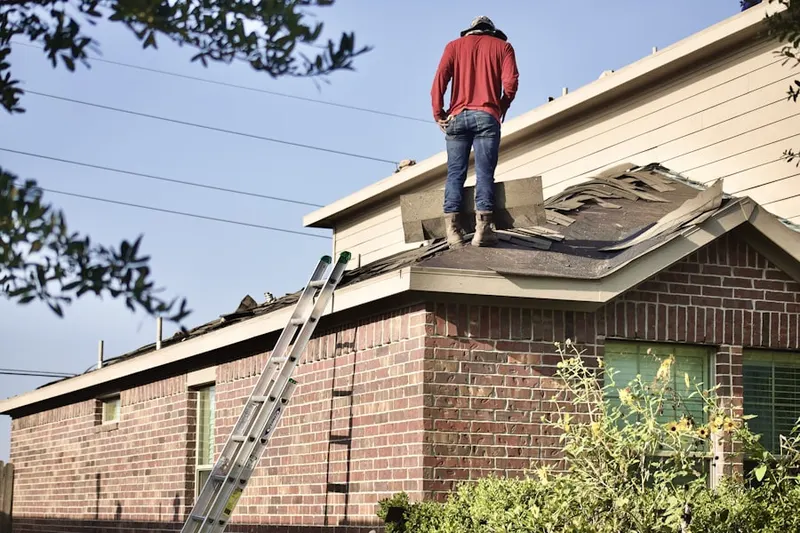 Professional roofer working on a residential roof in Villamay